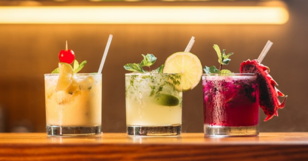 A picture of three colorful drinks that represent socializing in order to hint that the article is about socializing and dieting