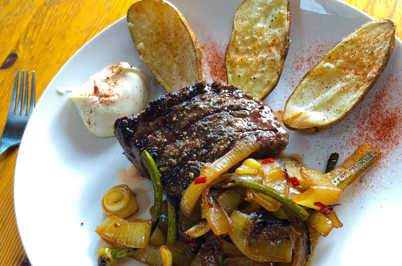 A picture of steak and potatoes and veggies. All things that Jakob Roze eats in a day as a fitness model 