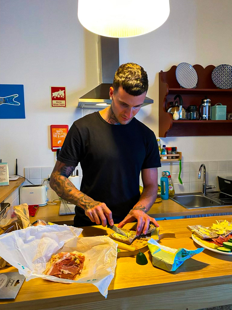 Jakob in the kitchen cooking a home made meal from ingredients he bought at the grocery store