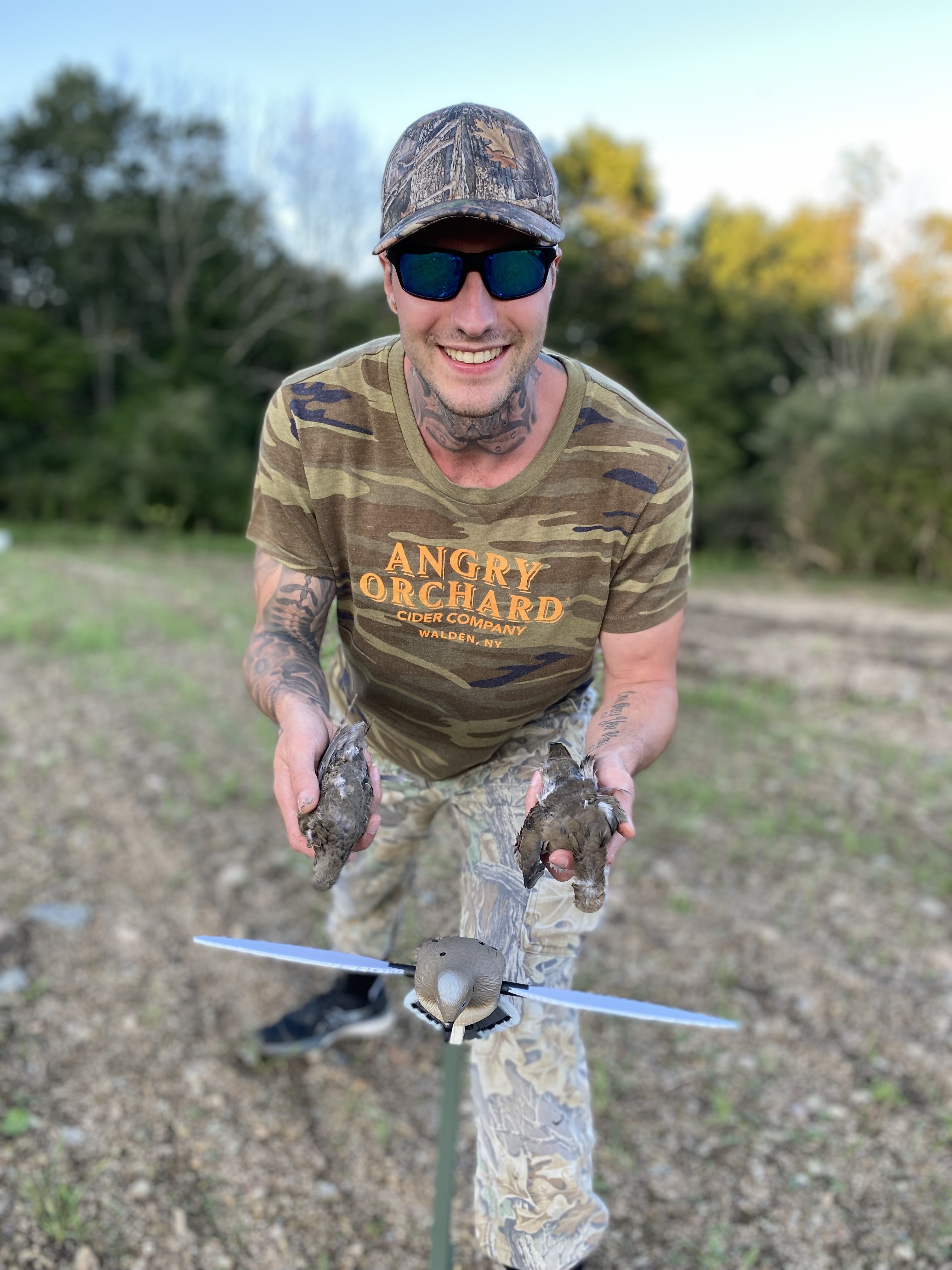 A picture of Jakob Roze holding two doves that he hunted for outdoor exercise 