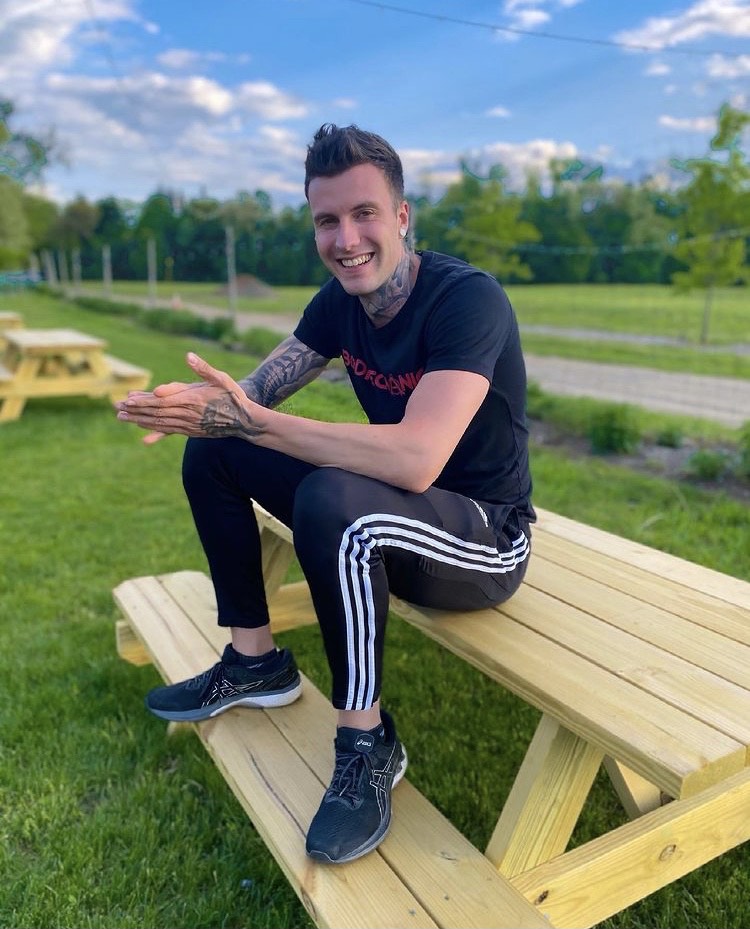 A picture of Personal Trainer Jakob Roze sitting on a bench in Stone Ridge New York