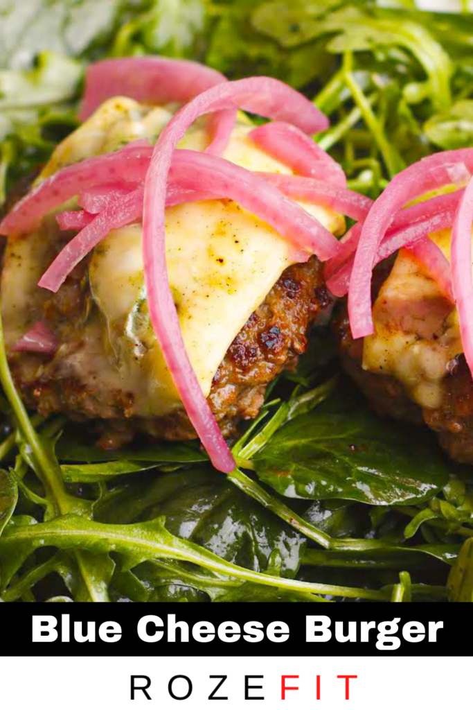 A picture of weekday recipe #2, Bunless Blue cheese Burgers. There are two patties with melted blue cheese served on top of a bed of salad greens.