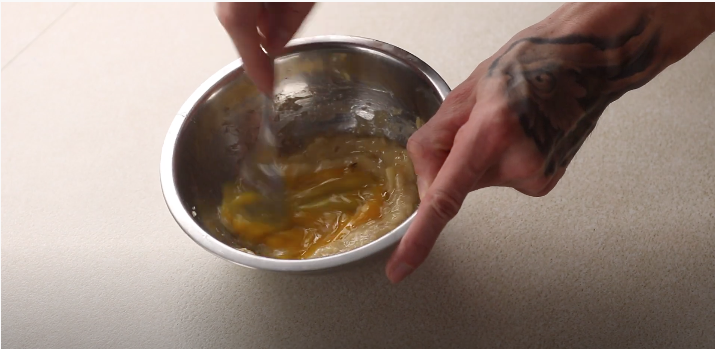 Egg and banana mixture being whipped by hand