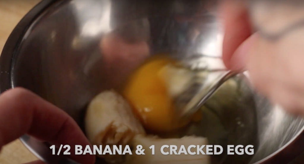 Banana and Egg mixture with text that reads '1/2 banana & 1 cracked egg'