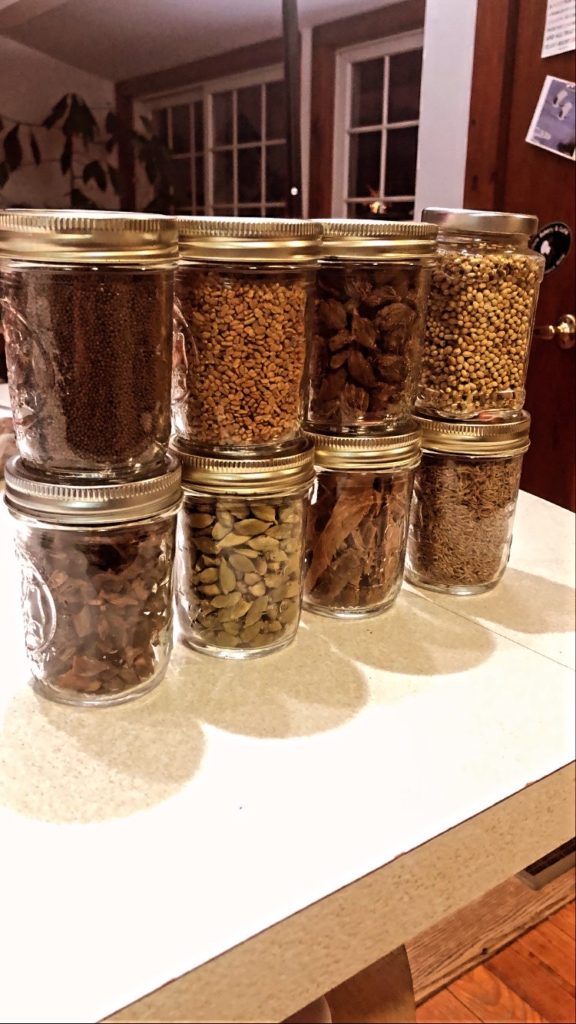 8 Jars of various spices used to flavor recipes for fat loss.