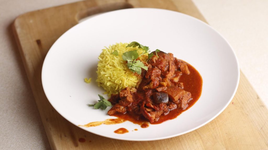 A healthy looking meal that has meat in sauce with rice and is high in protein which keeps your energy levels high.