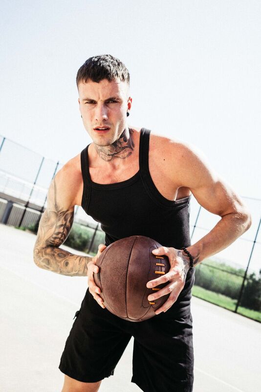 A picture of personal trainer Jakob Roze holding an exercise ball.