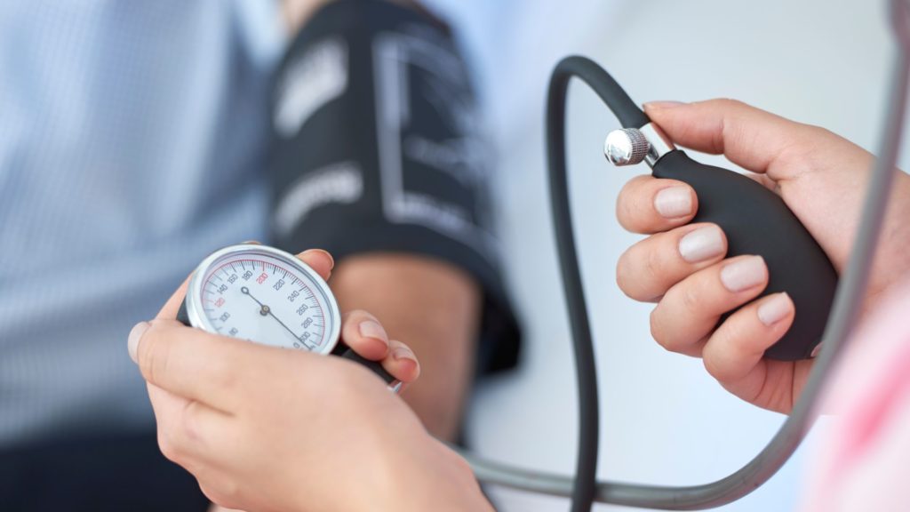 A doctor taking a patient's blood pressure. 