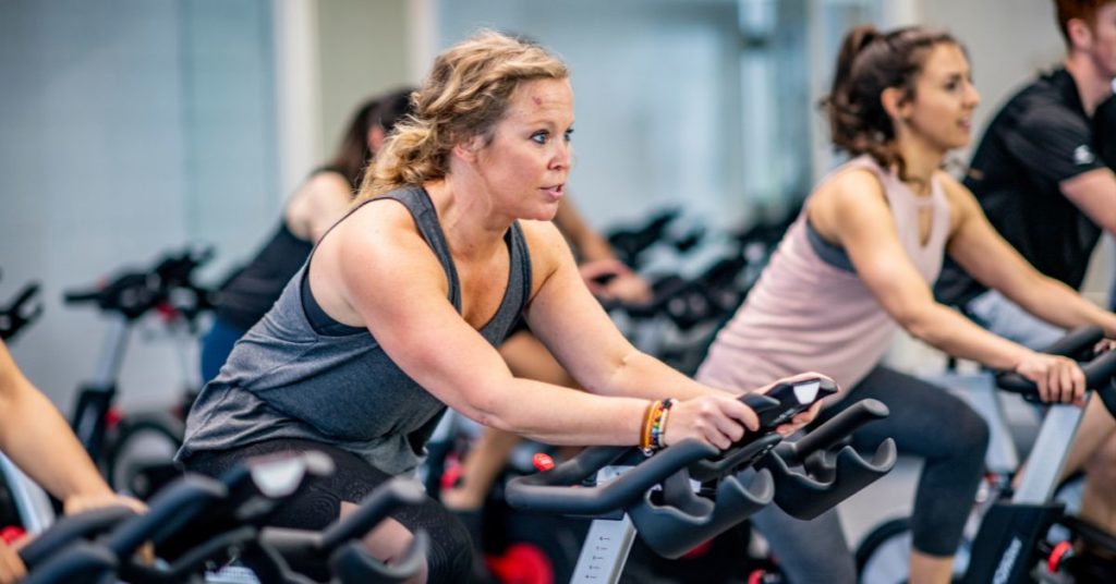 A woman performing cardio on an exercise bike