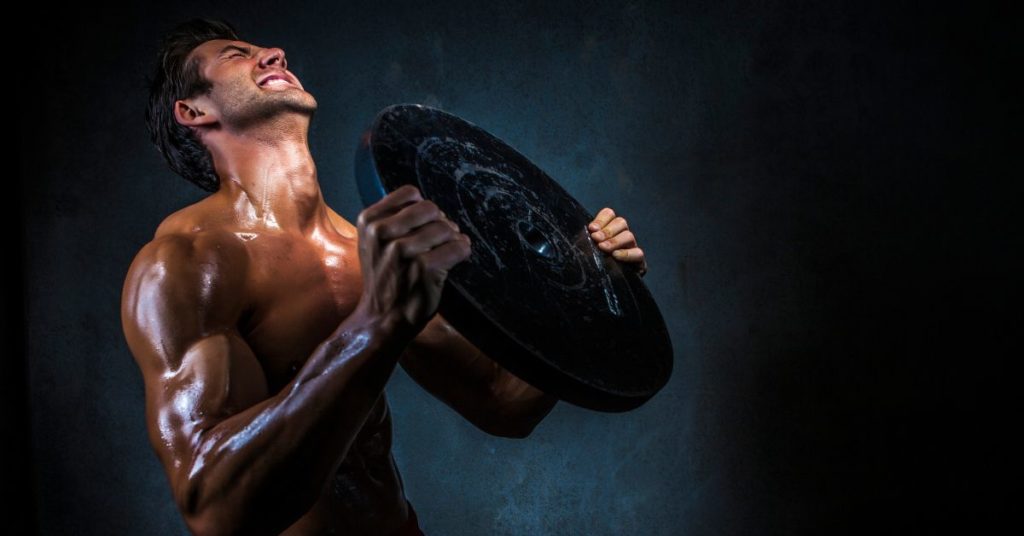 A man lifting weights to exhaustion 