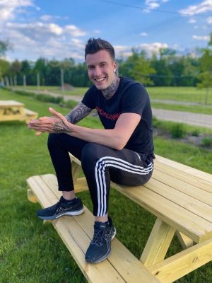 Personal Trainer Jakob Roze sitting on a bench in Stone Ridge New York
